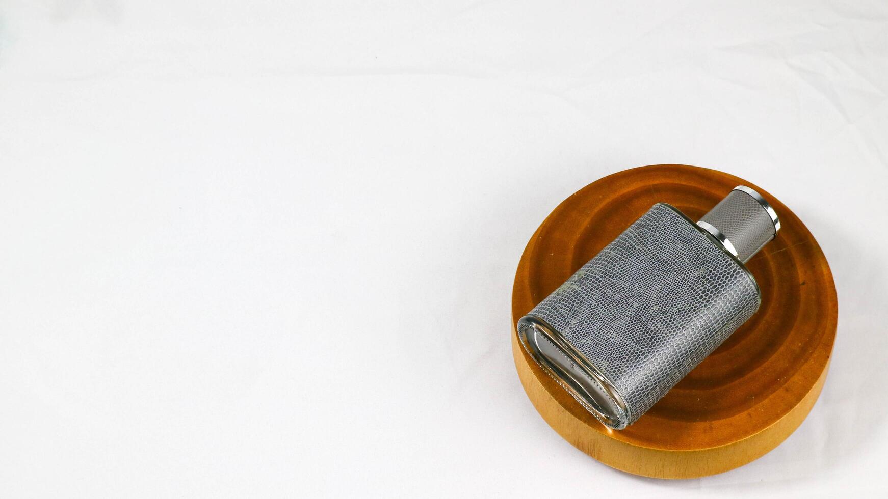 a gray and black metal pipe sitting on top of a wooden stand isolated on white photo