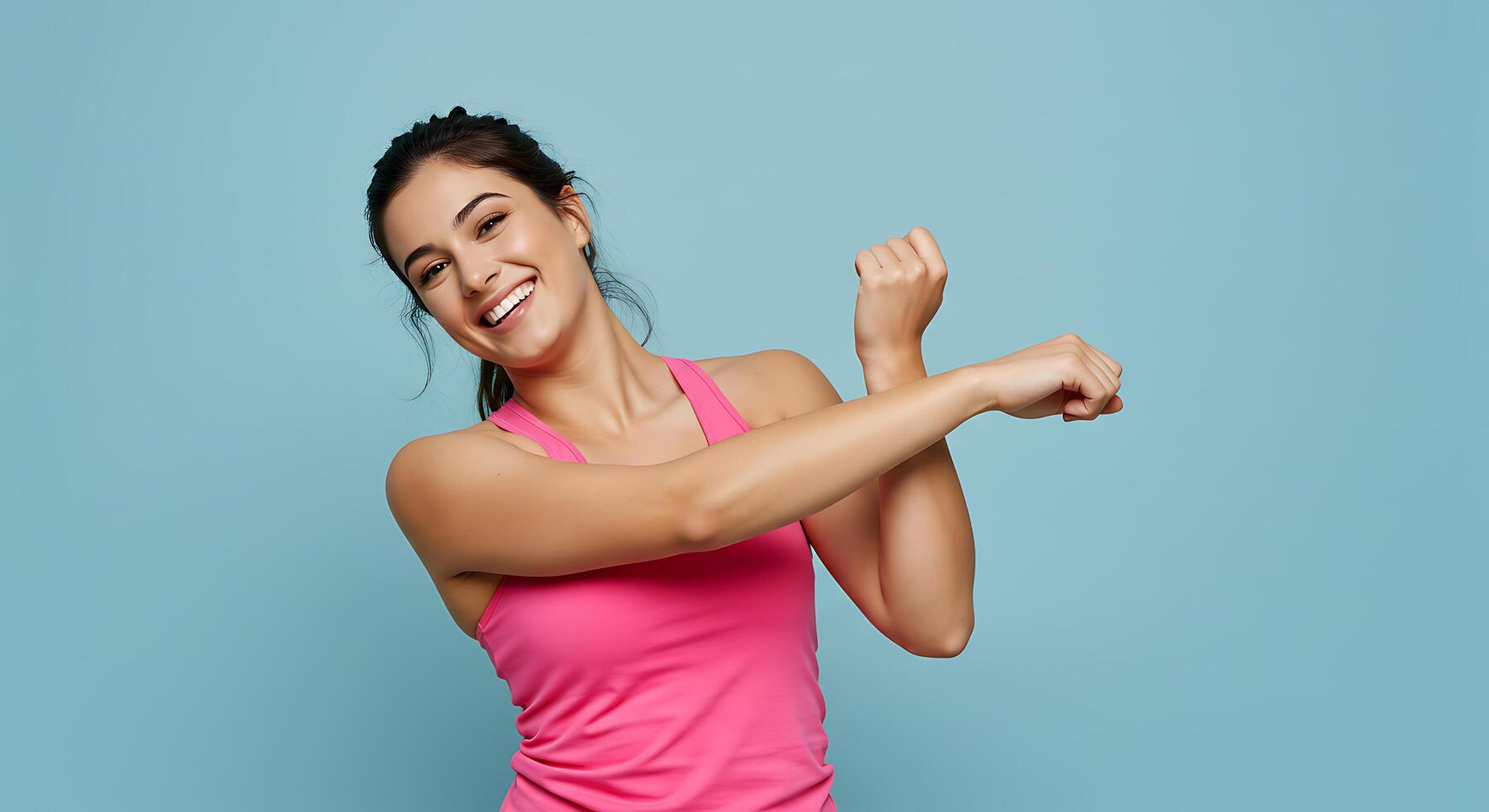 A woman in a pink top is stretching her arm photo