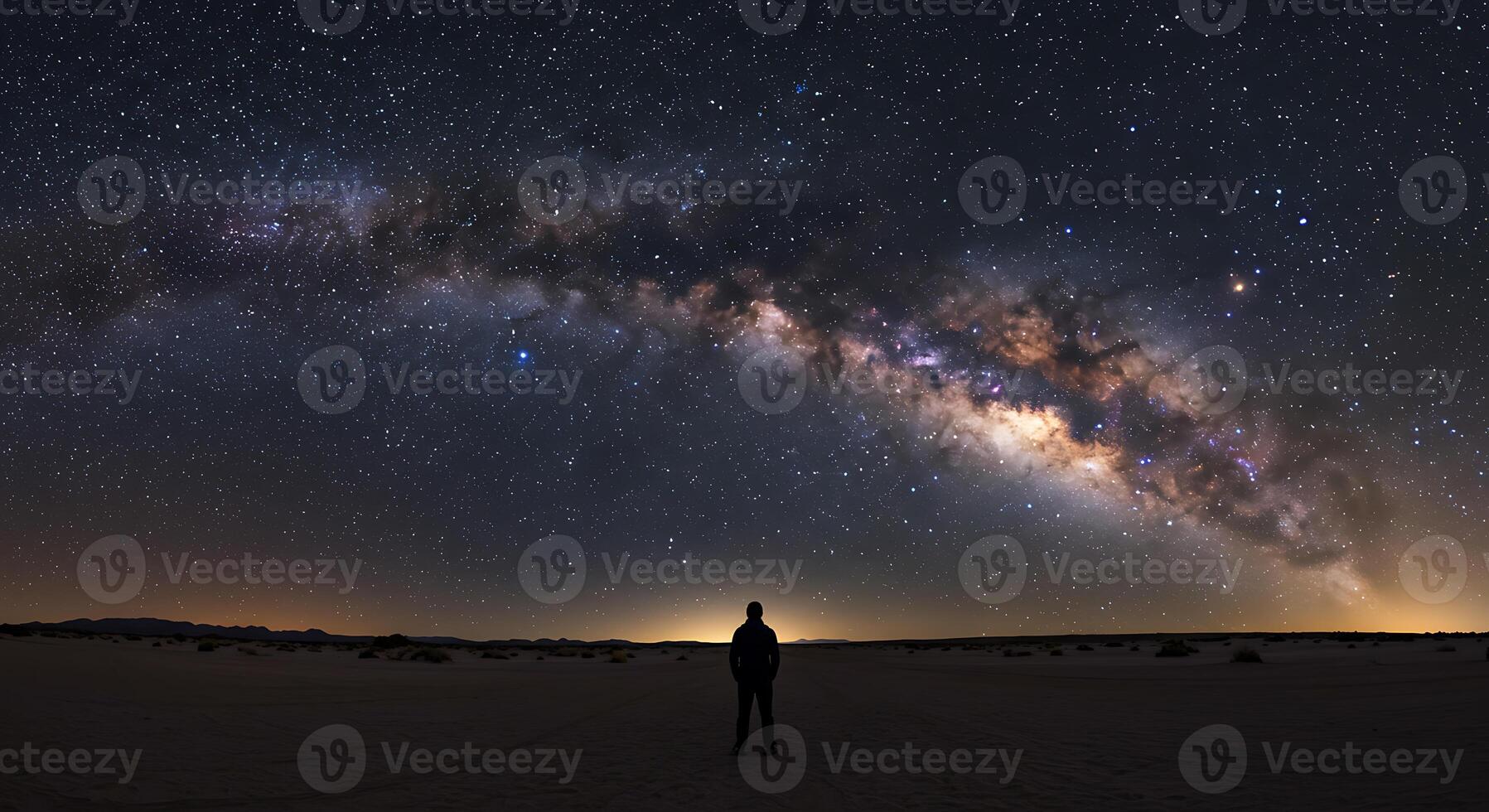 Solitary Figure Silhouetted Against a Majestic Milky Way photo