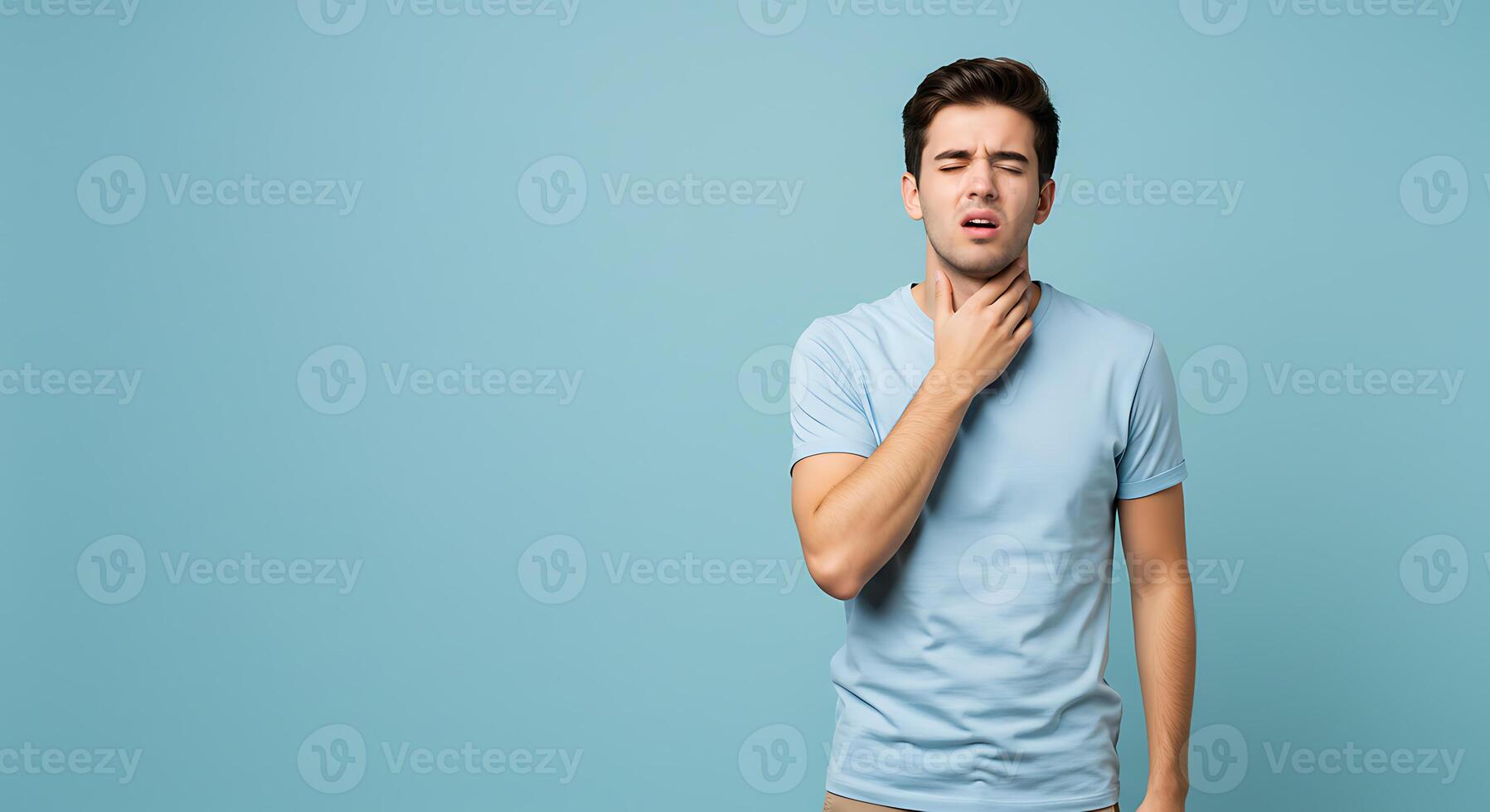 Man in Light Blue Shirt Holding Throat Feeling Sore Minimalist Pose photo