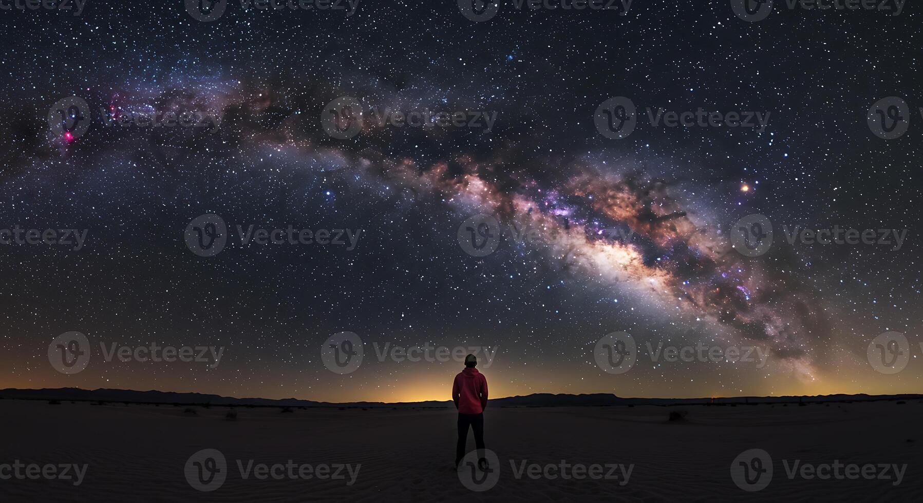 Solitary Figure Underneath the Majestic Milky Ways Celestial Arc photo