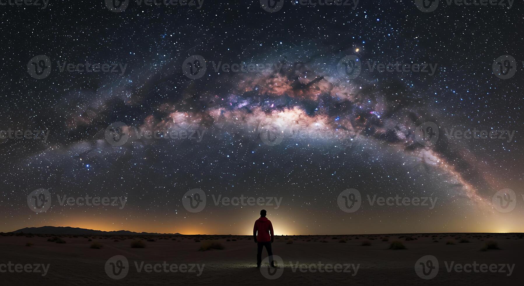 Solitary Figure Gazing at Majestic Milky Way A Night Sky Panorama photo