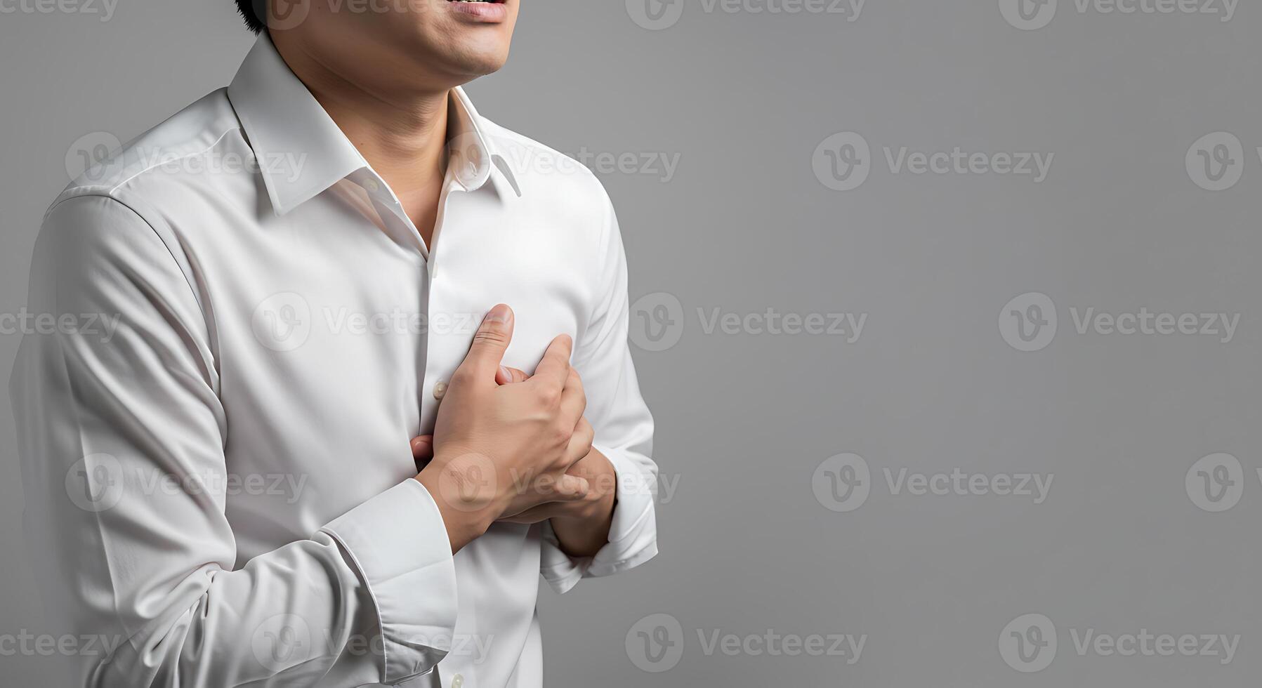 Man in White Shirt Grasping Chest A Serious Medical Moment photo