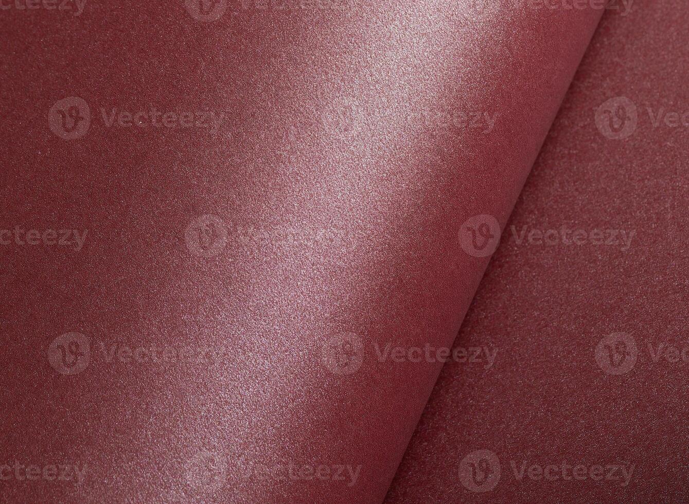 Elegant dark burgundy paper texture with a shimmering, glittering finish and subtly rolled edges. photo