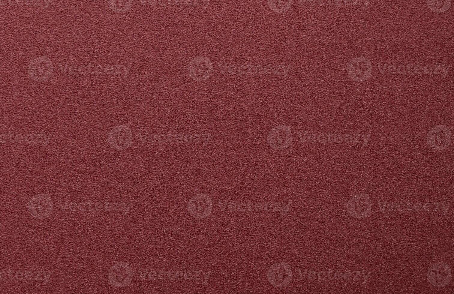 Burgundy paper background with a matte texture and fine, tactile surface. Deep, rich red tones photo