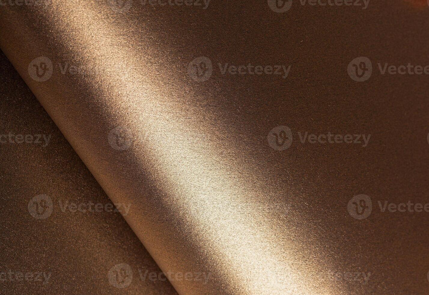 Warm gold and bronze paper background with a glossy, pearlescent texture and shimmering glitter photo