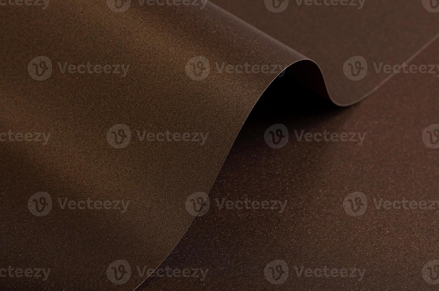 Warm brown paper background with a smooth, grainy texture and metallic bronze shimmer. A subtle photo