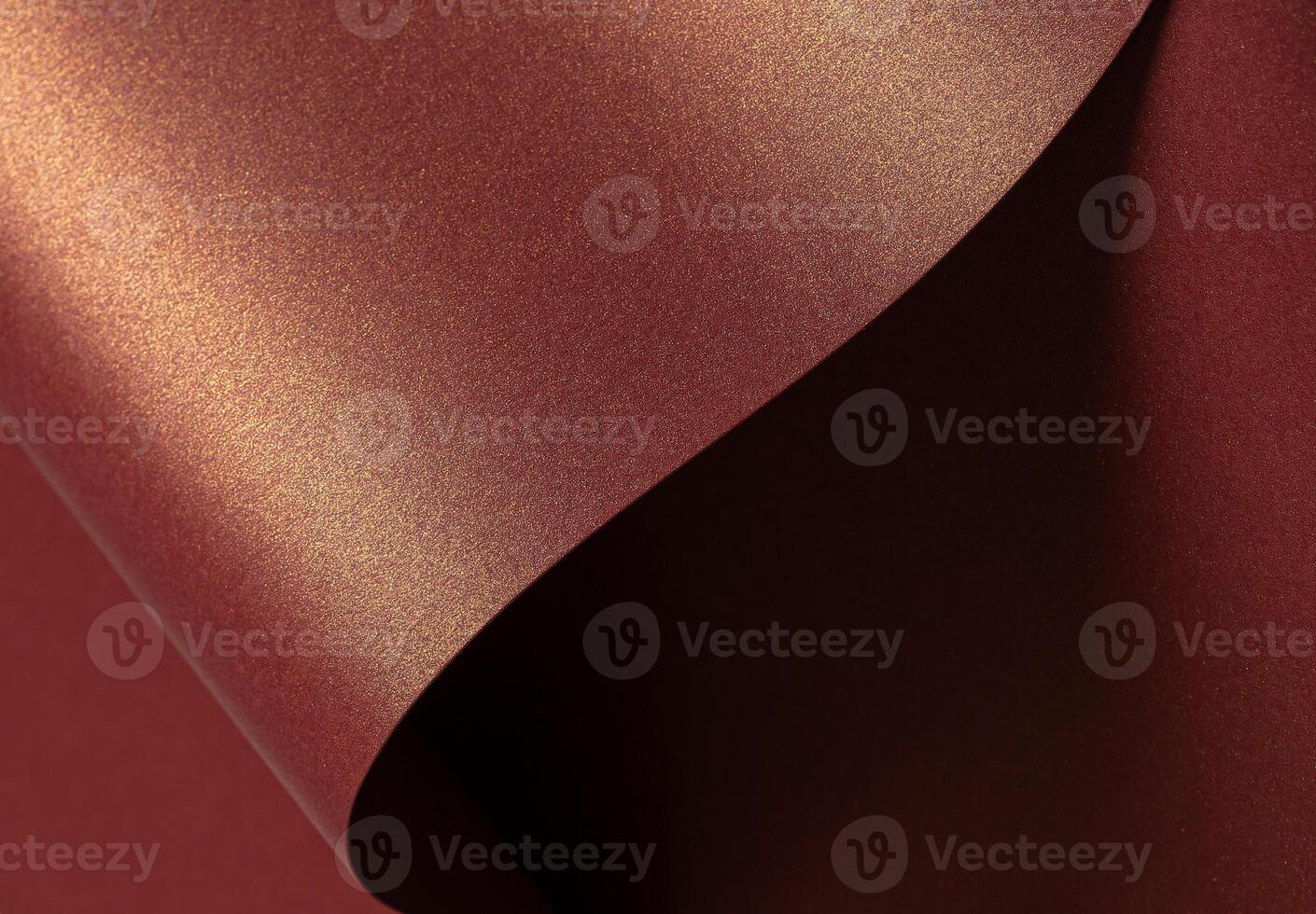 Burgundy paper background with a glossy, pearlescent texture and shimmering metallic finish. Rich photo