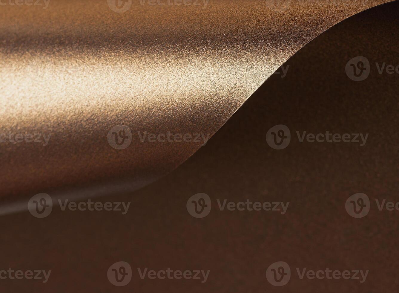 Warm gold and bronze paper background with a glossy, pearlescent texture. Shimmering metallic tones photo