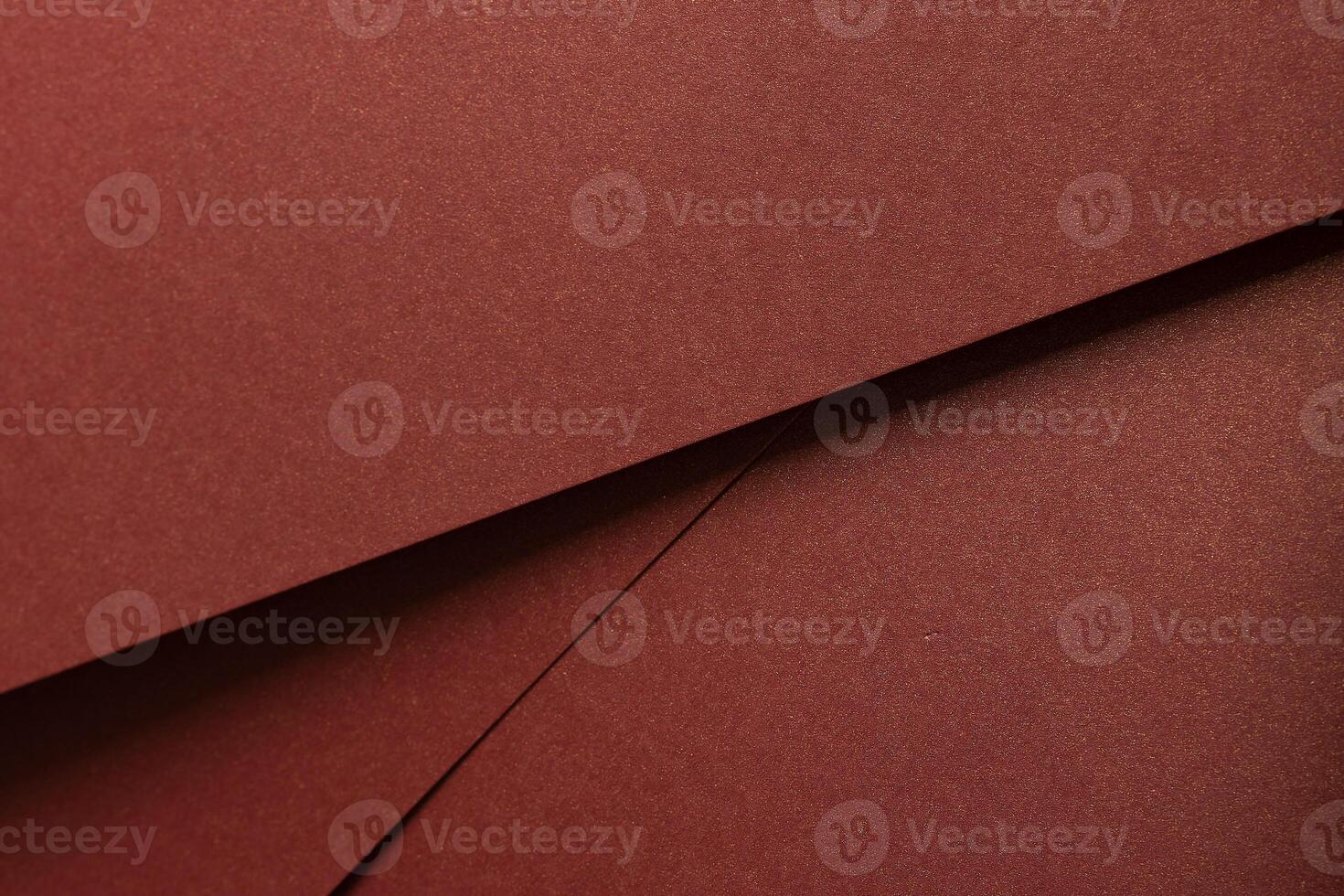 Burgundy paper background with a matte texture and subtle shimmer. Warm, rich tones create an photo