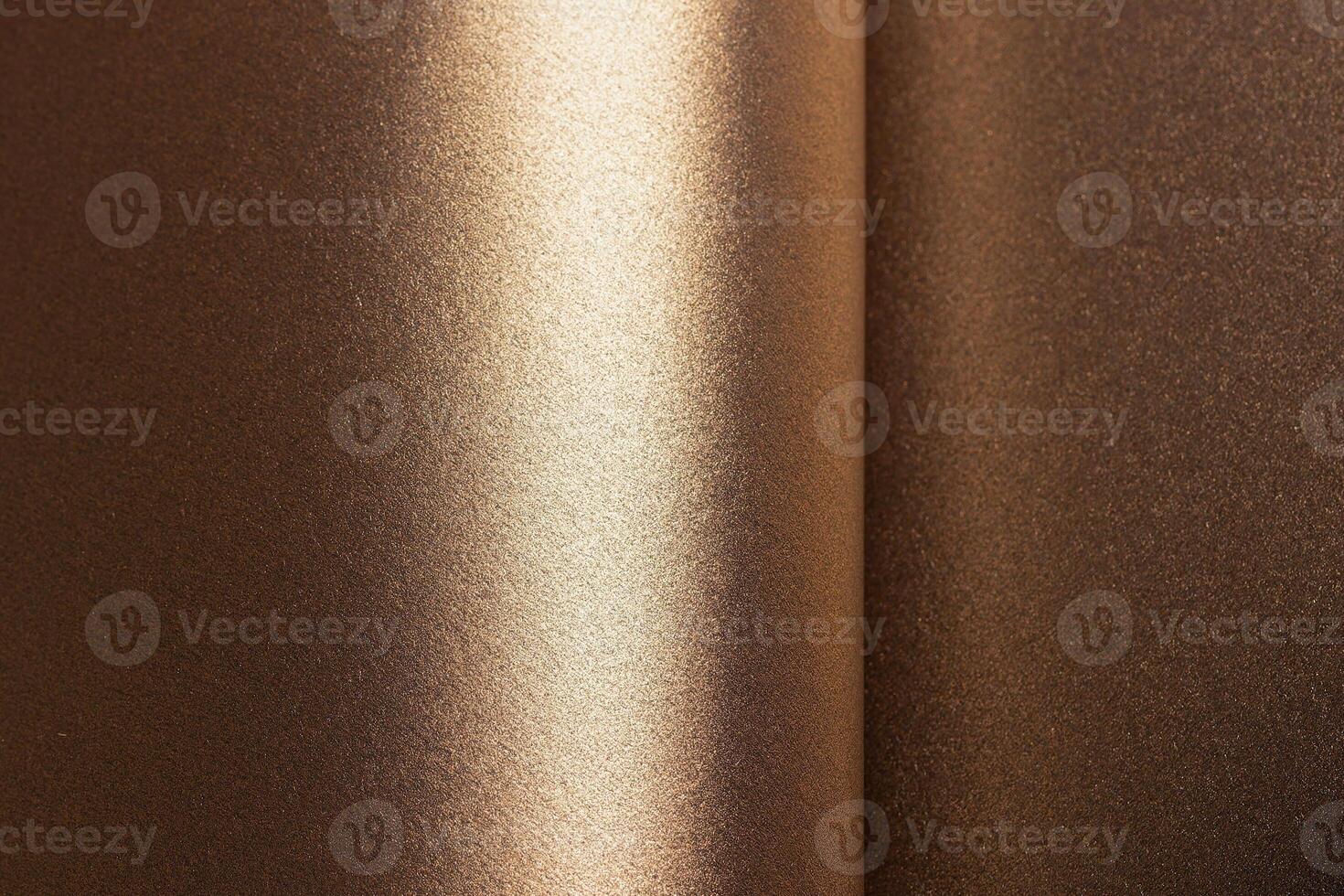Warm brown and gold paper background with a pearlescent, metallic texture and shimmering effect. The photo
