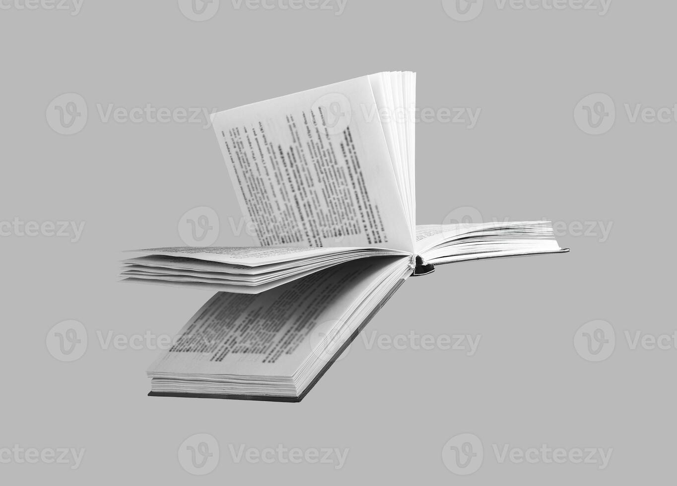 Open book, pages flipping at an angle, on white background. Modern hardcover with yellowed paper, photo