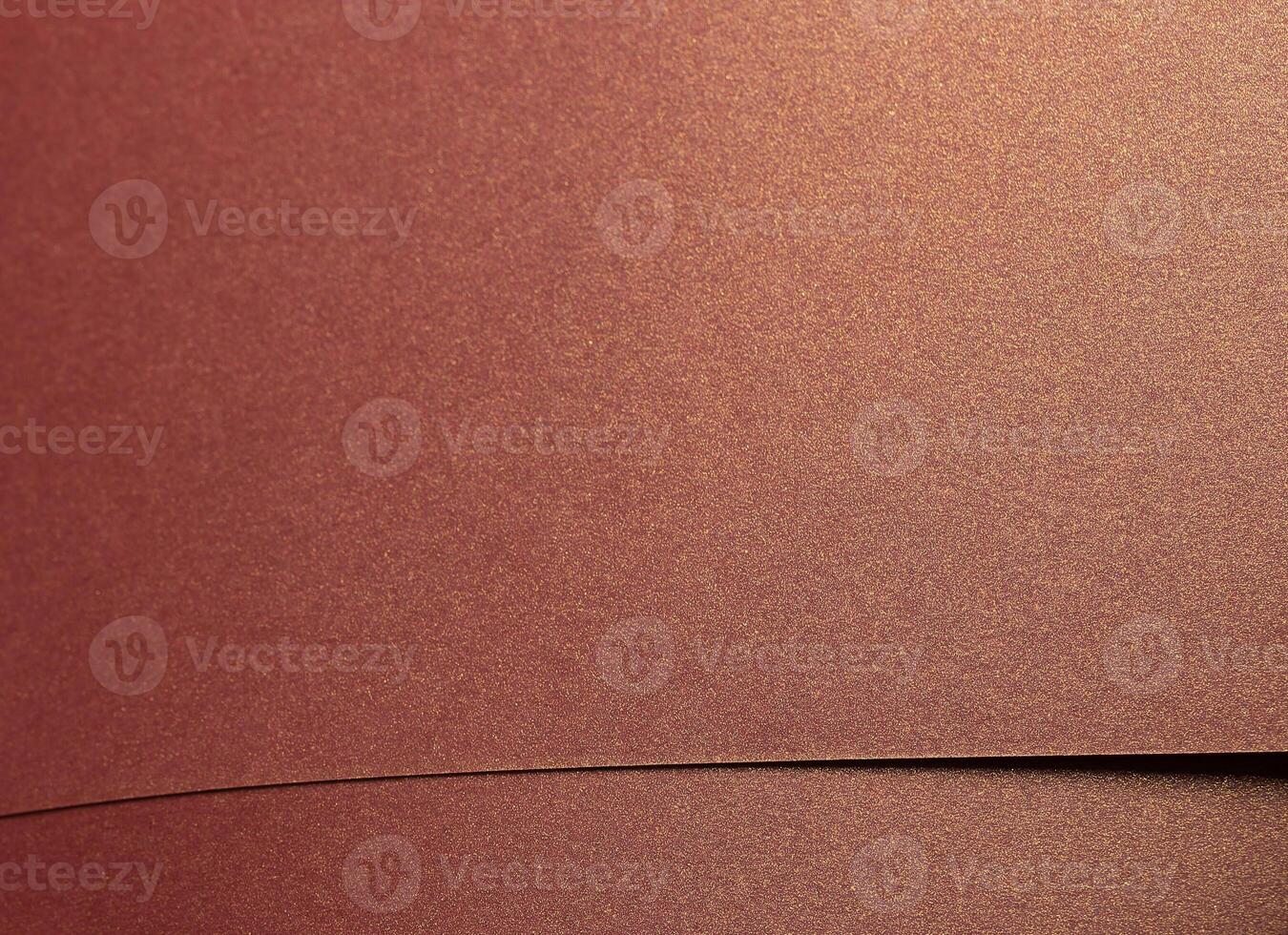 Burgundy paper background with a glossy, pearlescent texture and shimmering metallic finish. Rich, photo