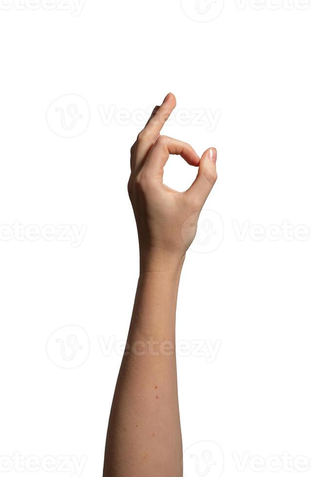 Hand making an OK sign with thumb and index finger forming a circle, symbolizing approval, photo