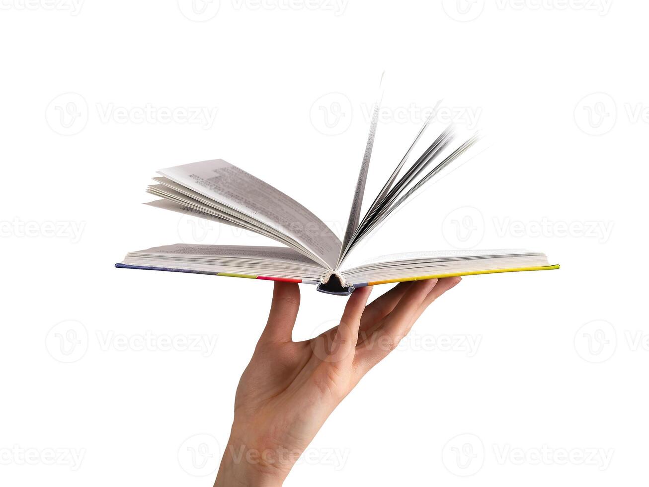 Open book held by hand, flipping pages. Modern hardcover, yellowed paper, symbolizing knowledge, photo