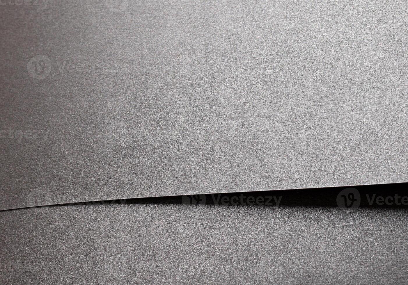 Gray metallic paper background with a pearlescent, glossy texture. Silver tones and a satin finish photo