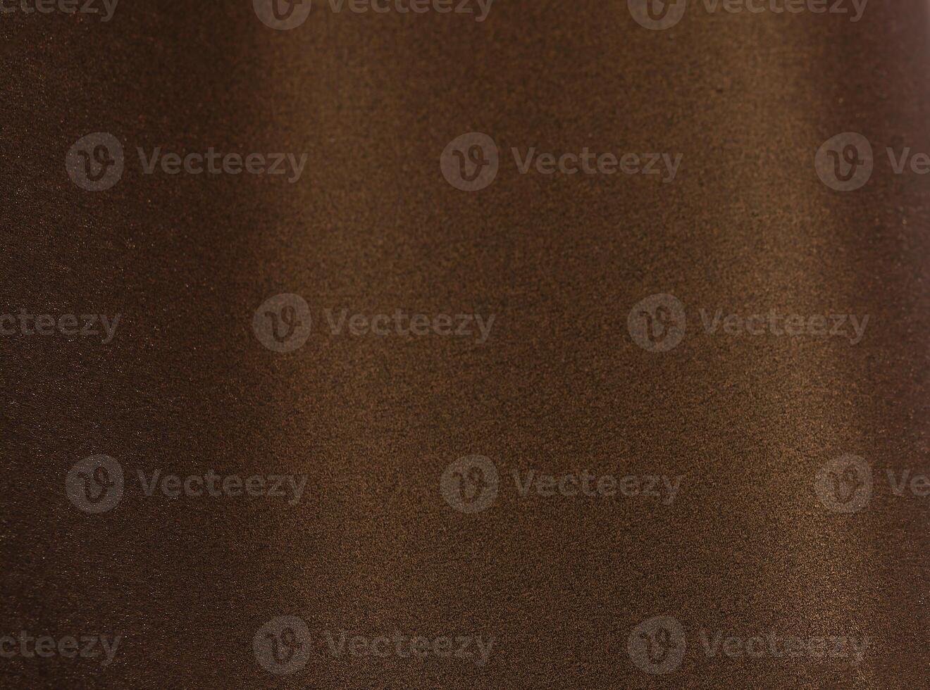 Rich brown paper background with a smooth, grainy texture and a subtle metallic shimmer. Warm gold photo