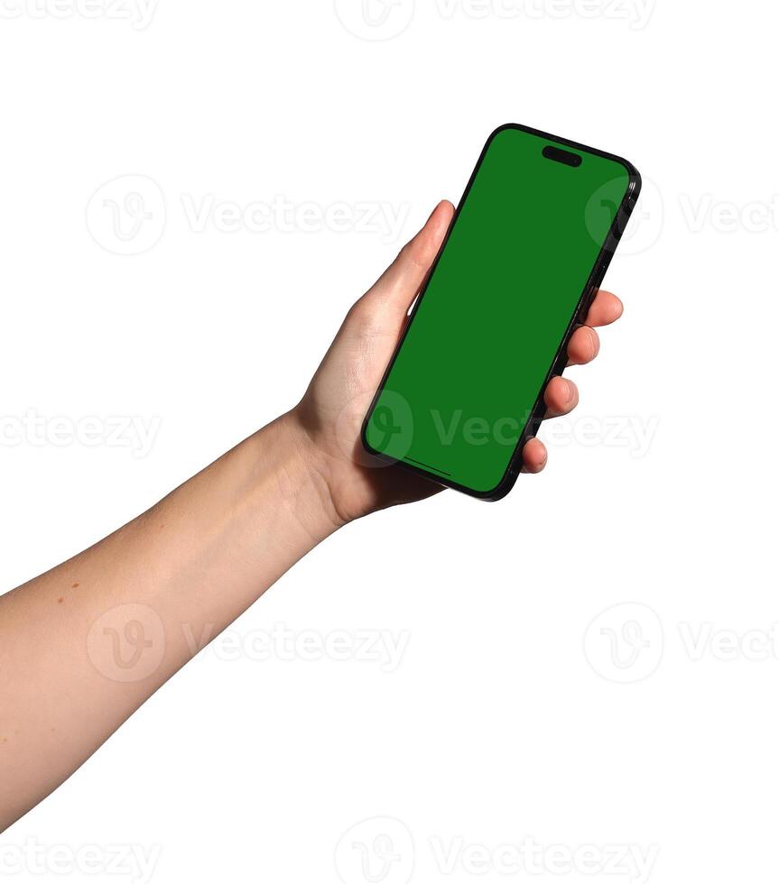 Hand holding a smartphone with an empty green chromakey screen. Female presenting mobile device for photo