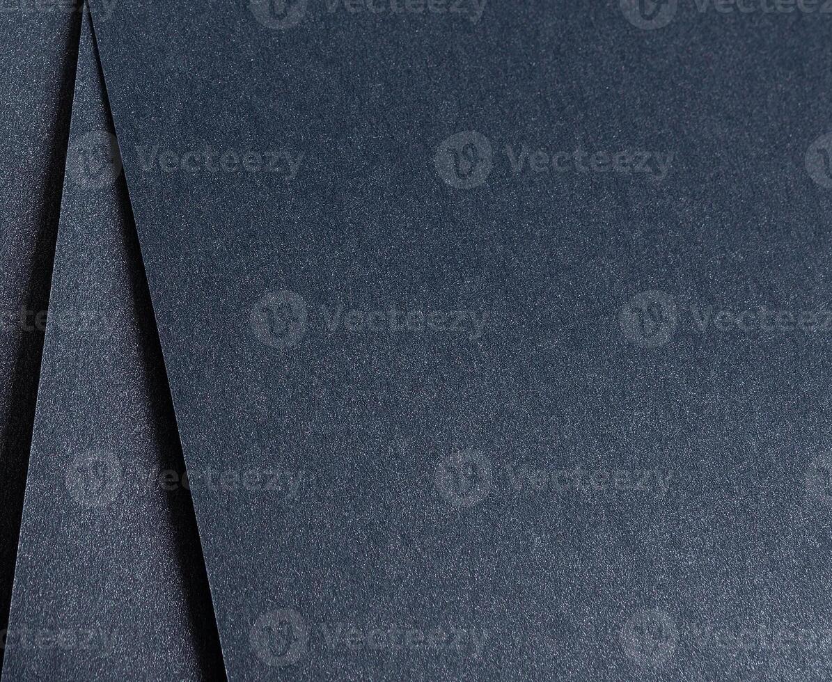 Dark blue paper background with a sleek, glossy texture and subtle shimmering finish. Rich, elegant photo