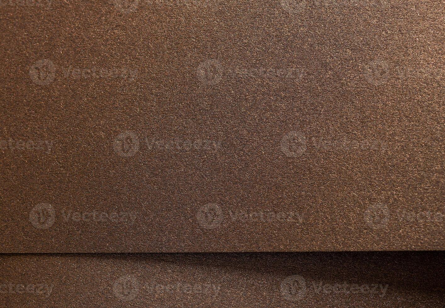 Warm gold and bronze paper background with a pearlescent, metallic texture and subtle shimmer. The photo