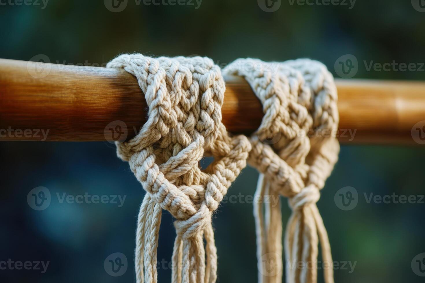 Two pieces of string are tied together on a wooden pole photo