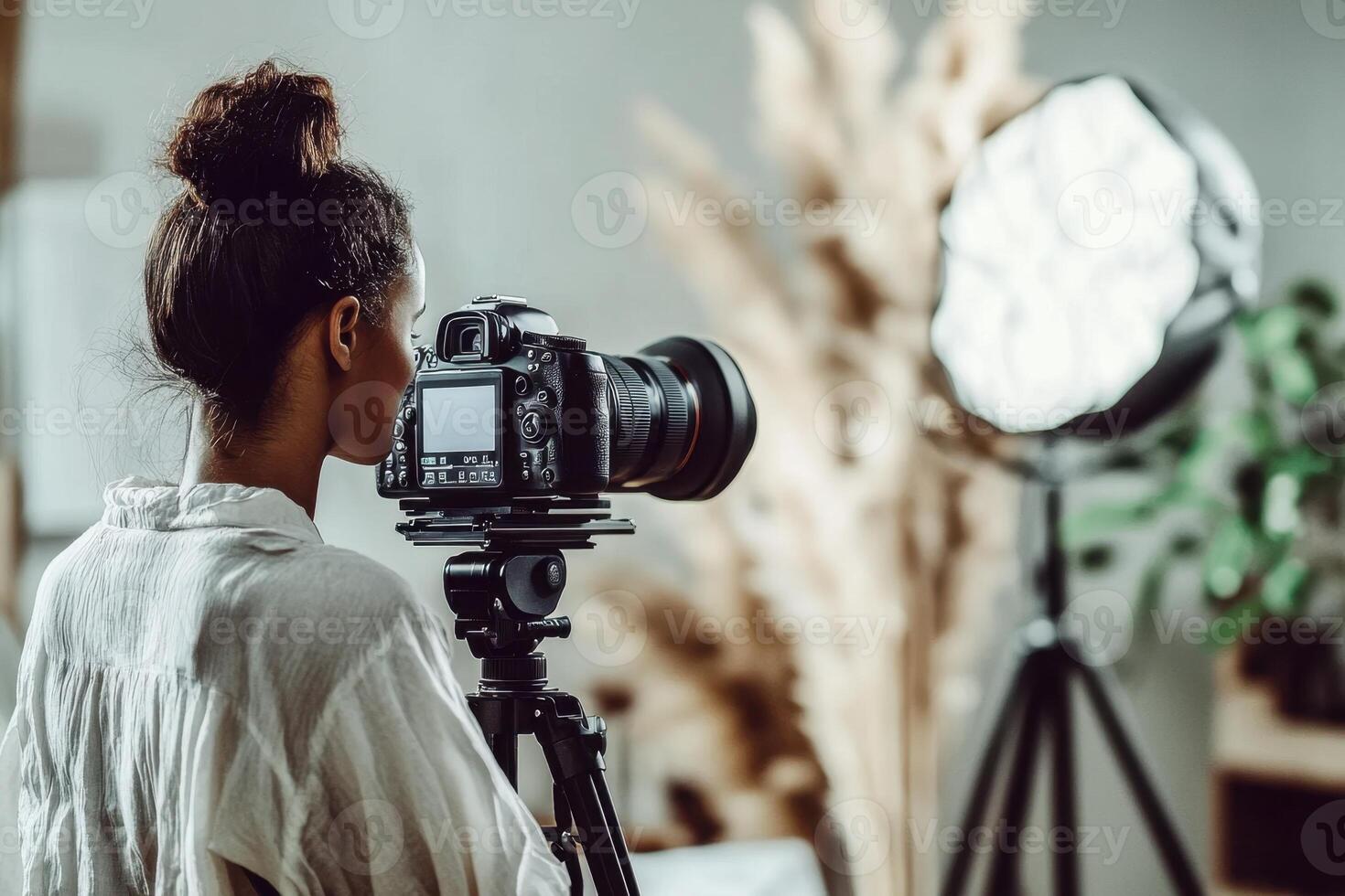 A woman is taking a picture with a camera photo