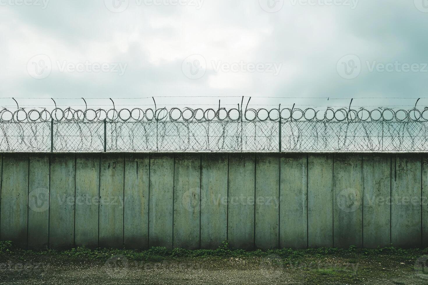 A wall with barbed wire on top of it photo