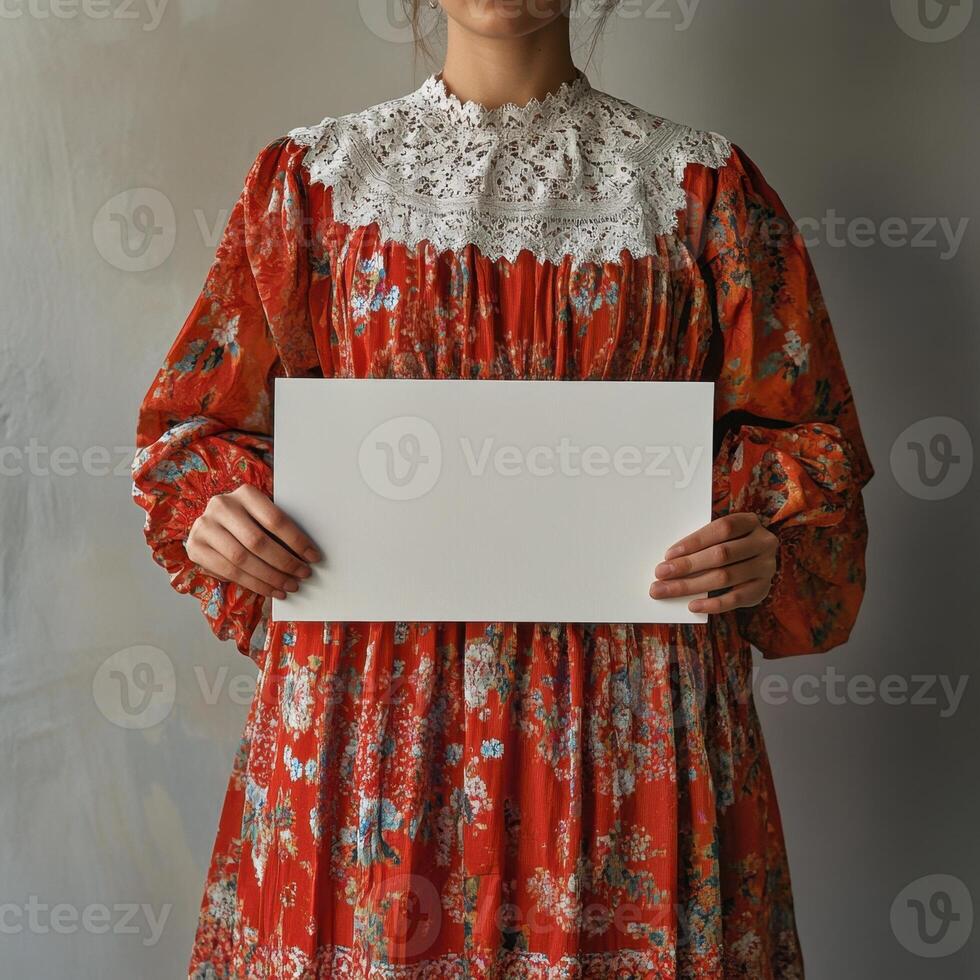 A woman is holding a white sign in front of her photo