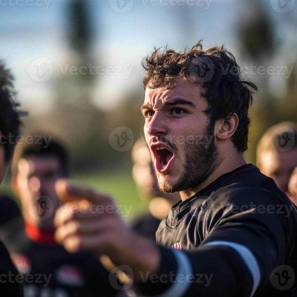 A man with a beard and a red shirt is pointing at something photo