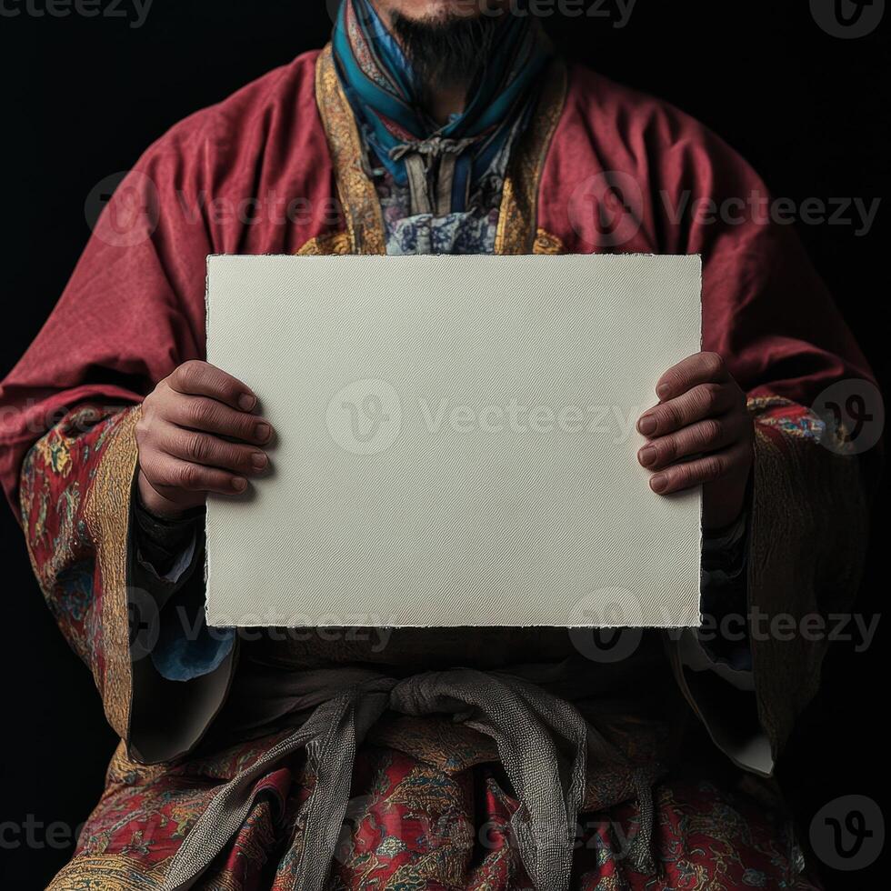 A man in a red robe holding a blank piece of paper photo