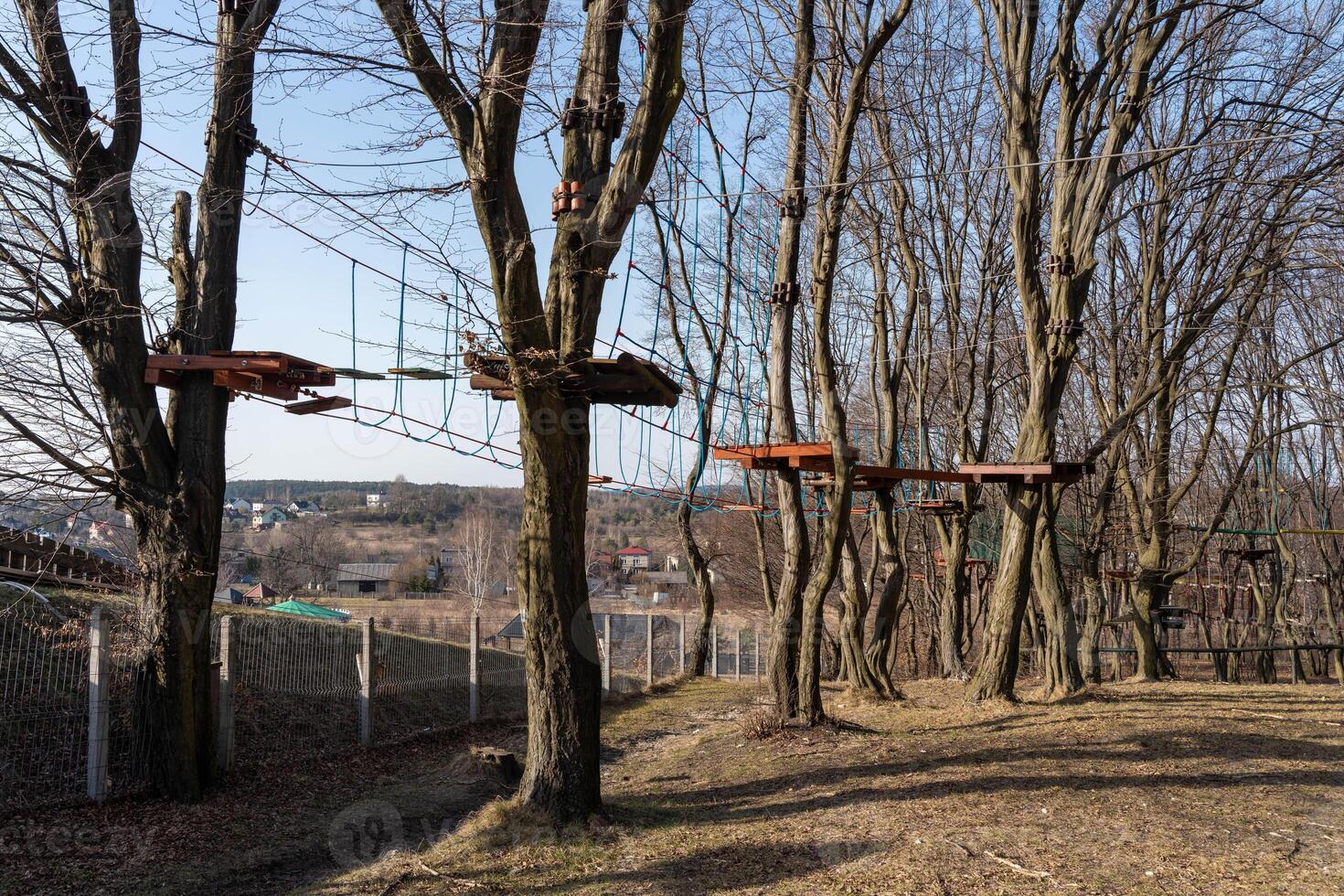 Rope Park Amid Bare Trees with Platforms and Rope Bridges in Winter photo