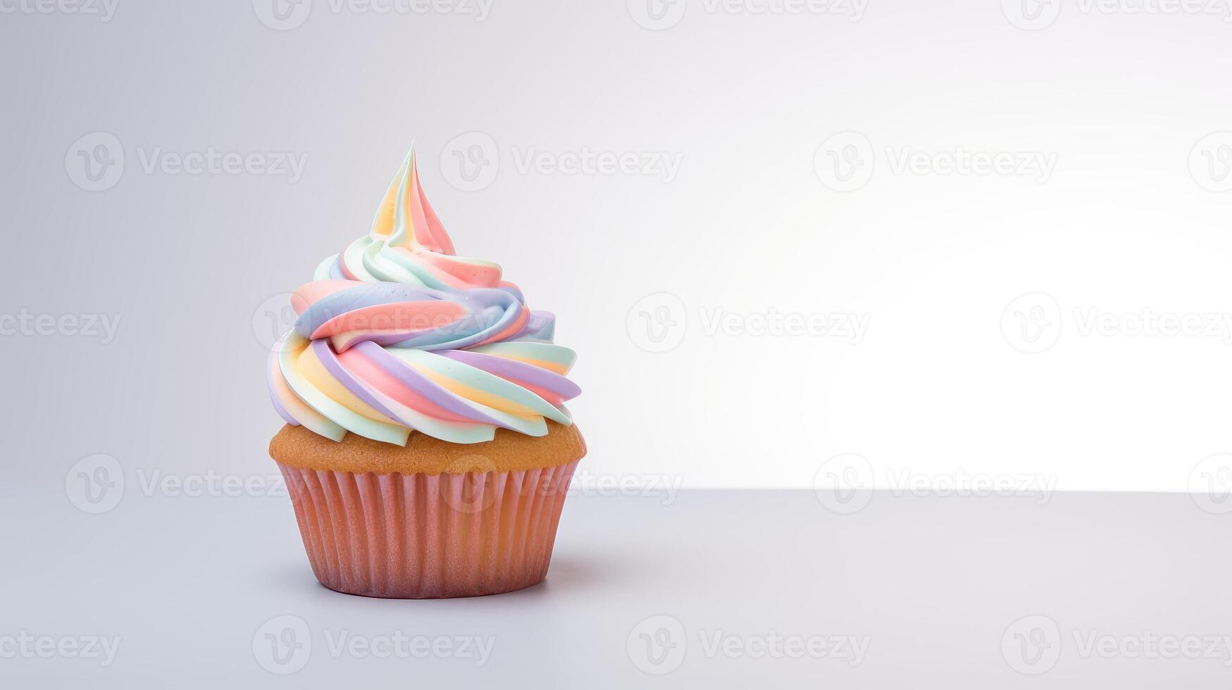 A cupcake with rainbow icing on top photo