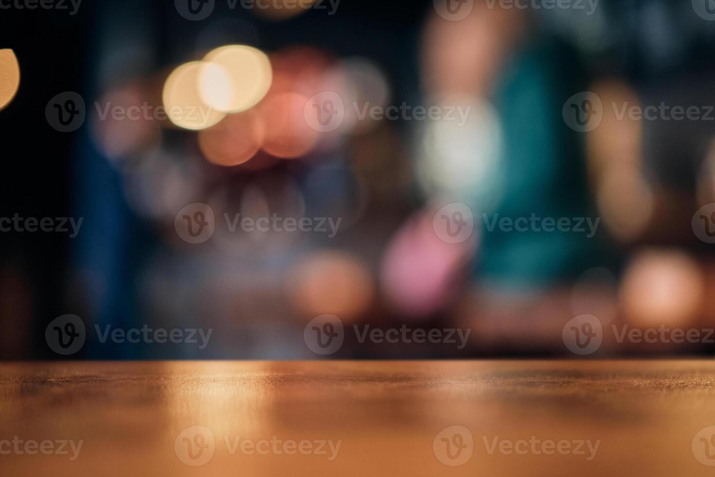 Wood table top on of abstract blurred restaurant lights background photo