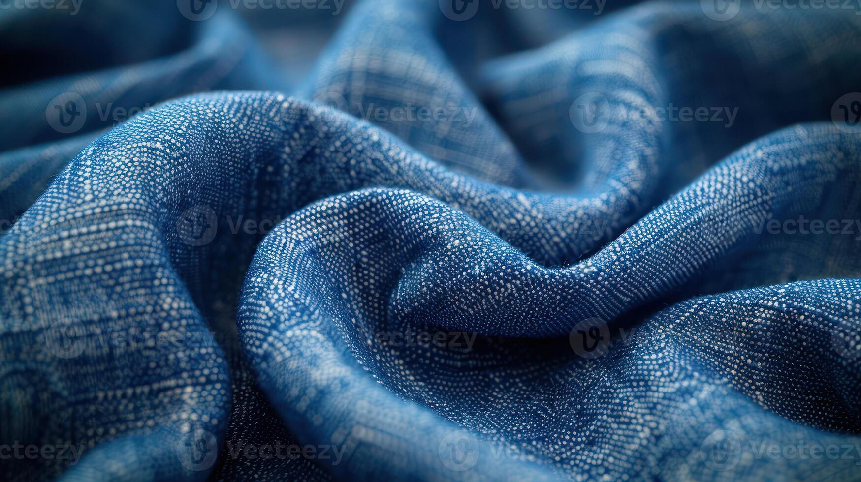 Close-up view of a vibrant blue textile with intricate woven patterns and soft folds. photo