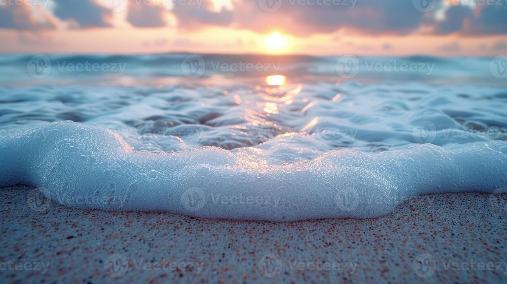Foamy ocean waves on a sandy beach at sunrise. photo
