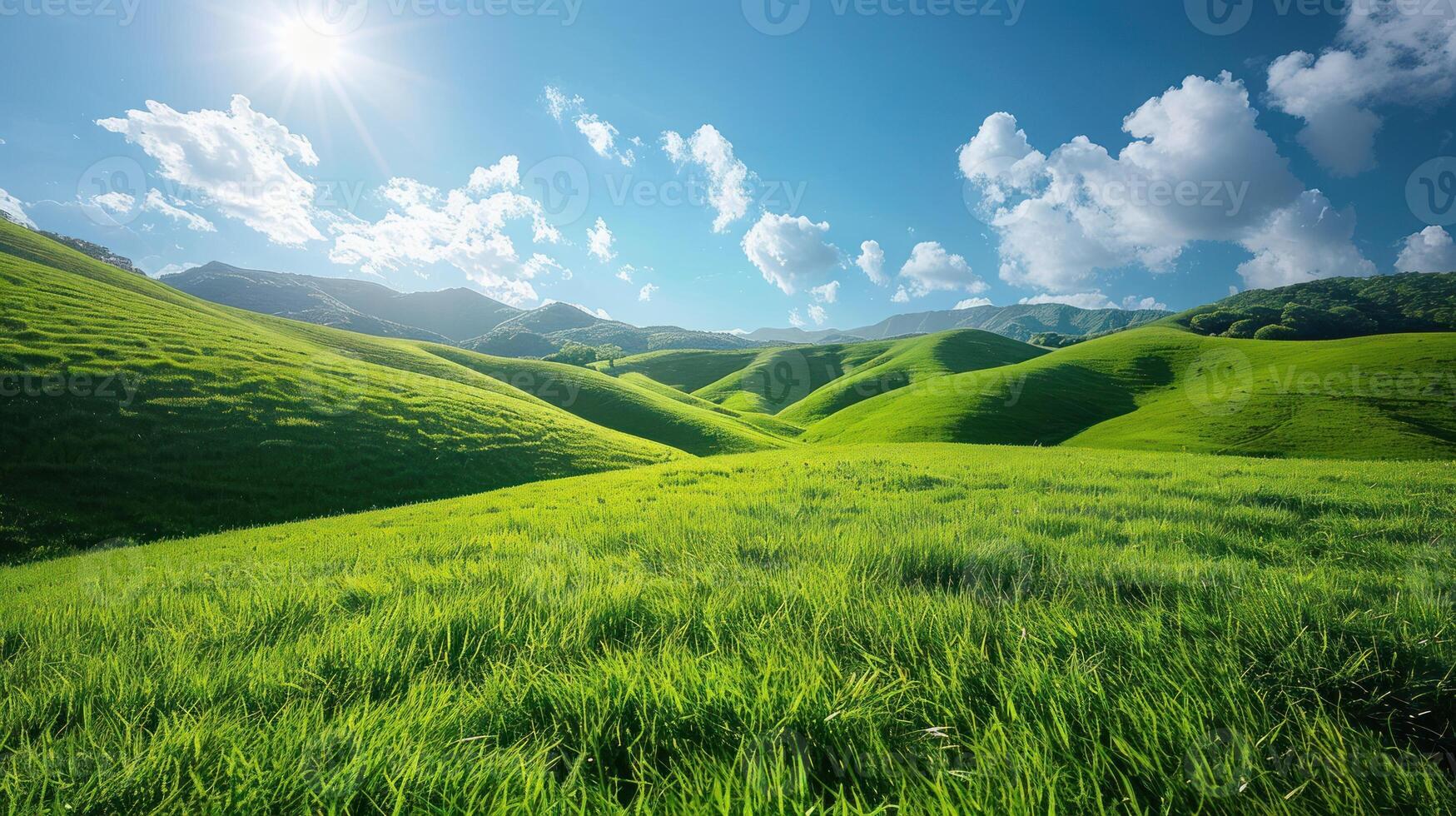 Lush green hills under a vibrant blue sky with sunlit clouds. Rolling hills covered in fresh green grass. Sunny day. Perfect summer scenery. Vast open meadow. Majestic landscape. photo