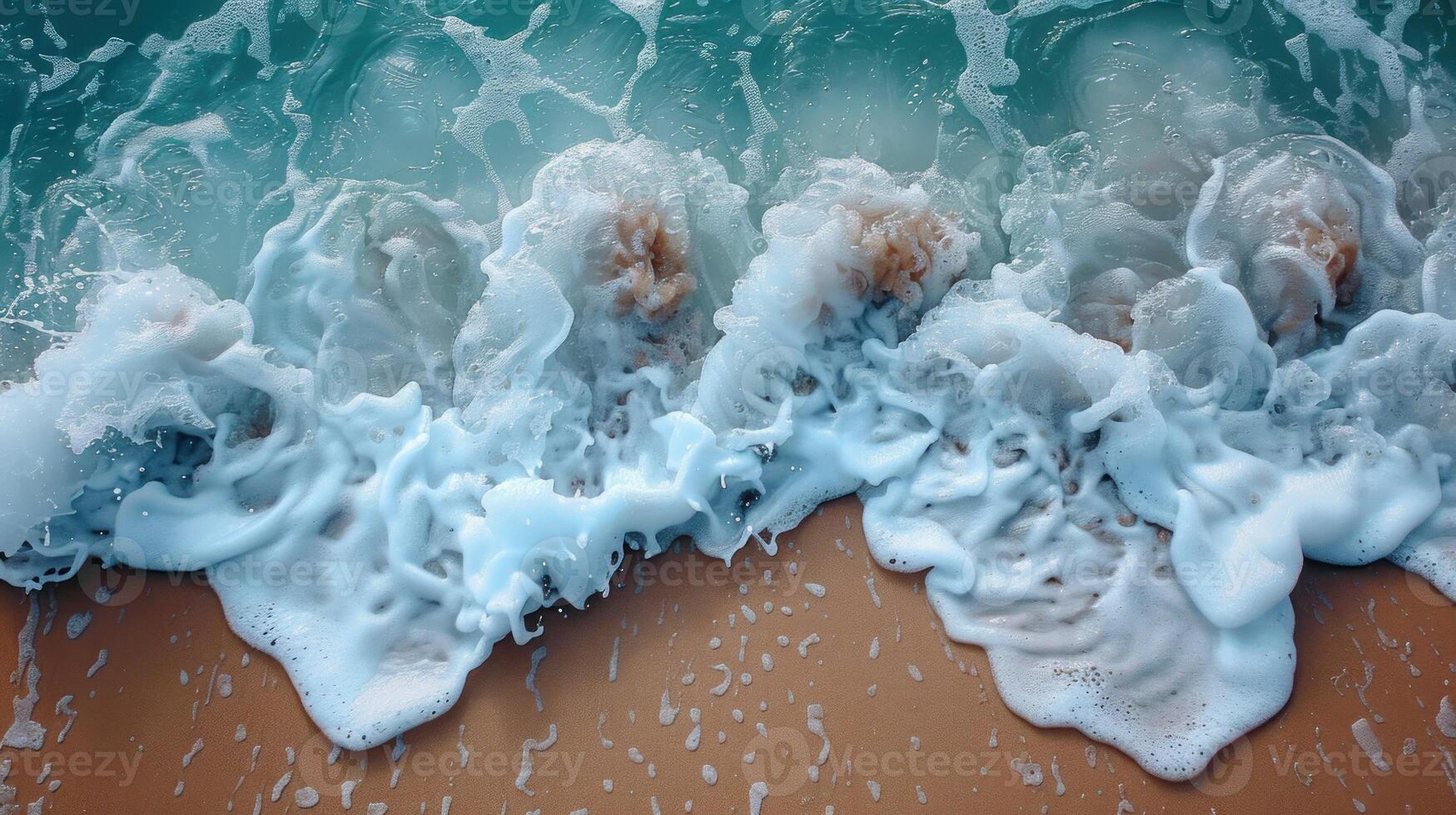 Foamy waves crashing on sandy beach. photo