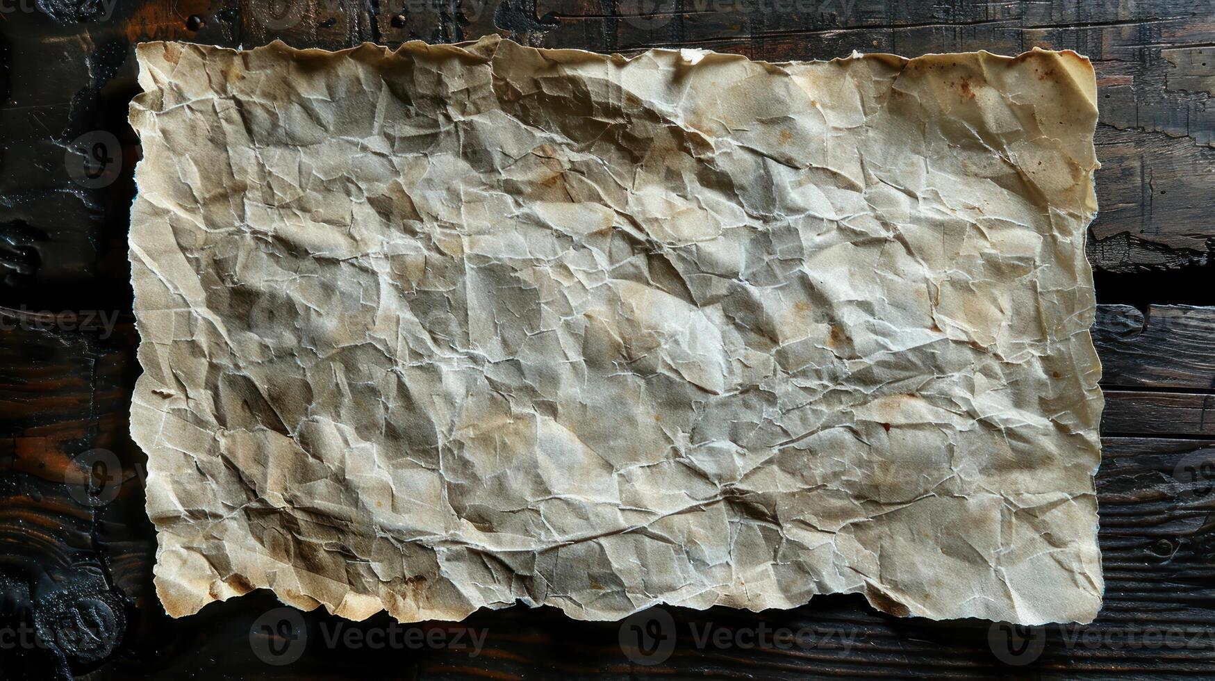 Aged, wrinkled paper sheet on dark wooden table. photo