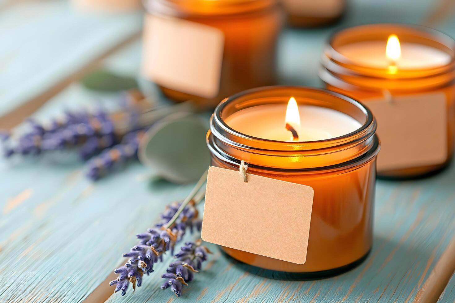 Soy wax candles in amber glass jars with kraft paper labels on wooden surface with lavender and photo