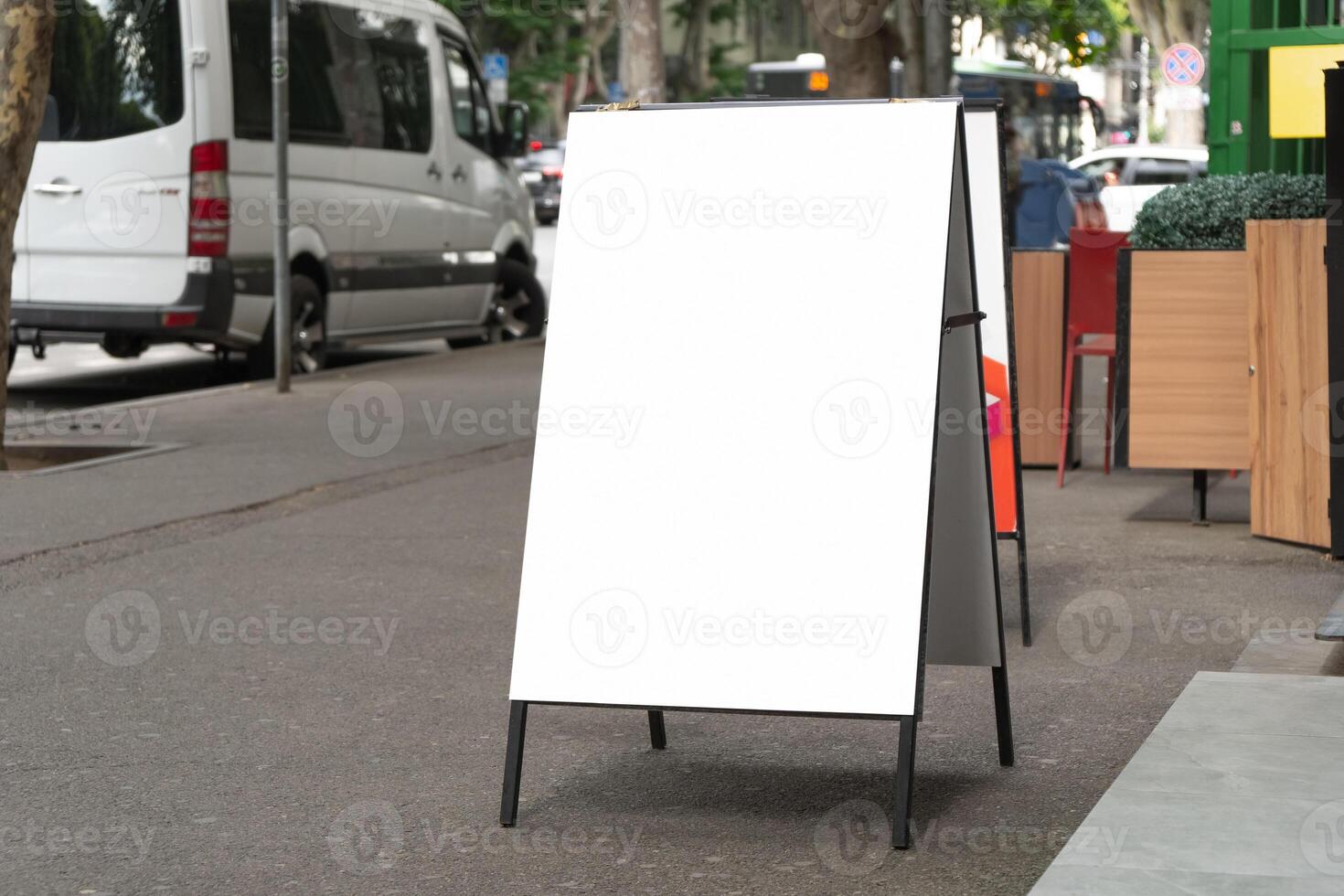 Side view of blank white sandwich board on a street. Portable folding billboard photo