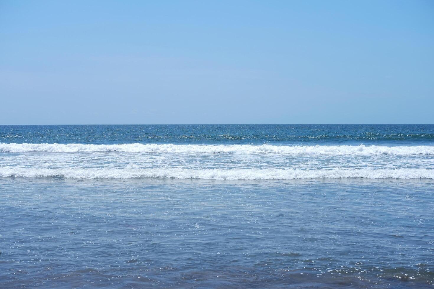 Landscape of horizontal calm blue sea with wave and cloud and blue sky on the beach in bright day. Travel destination summer of ocean in Asian. Copy space photo