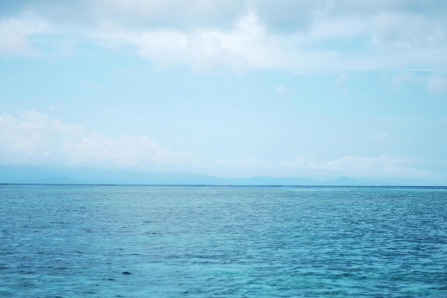 Landscape horizontal calm blue sea with wave and cloud and blue sky in bright day. Travel destination summer of ocean in Asian. Copy space photo