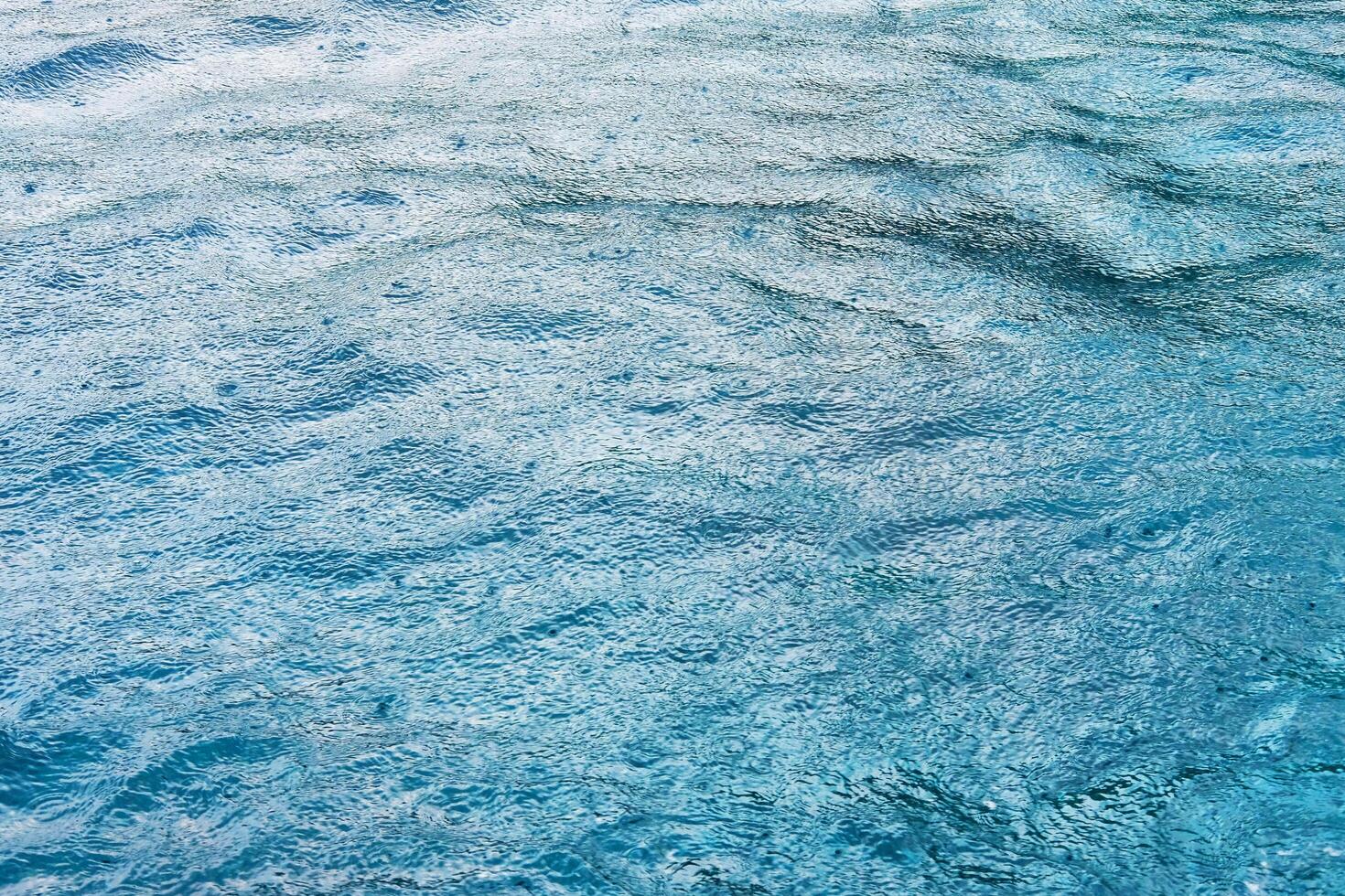Fresh of the rain falling in calm blue sea surface with feeling of relaxation and peace in tropical natural seasonal photo