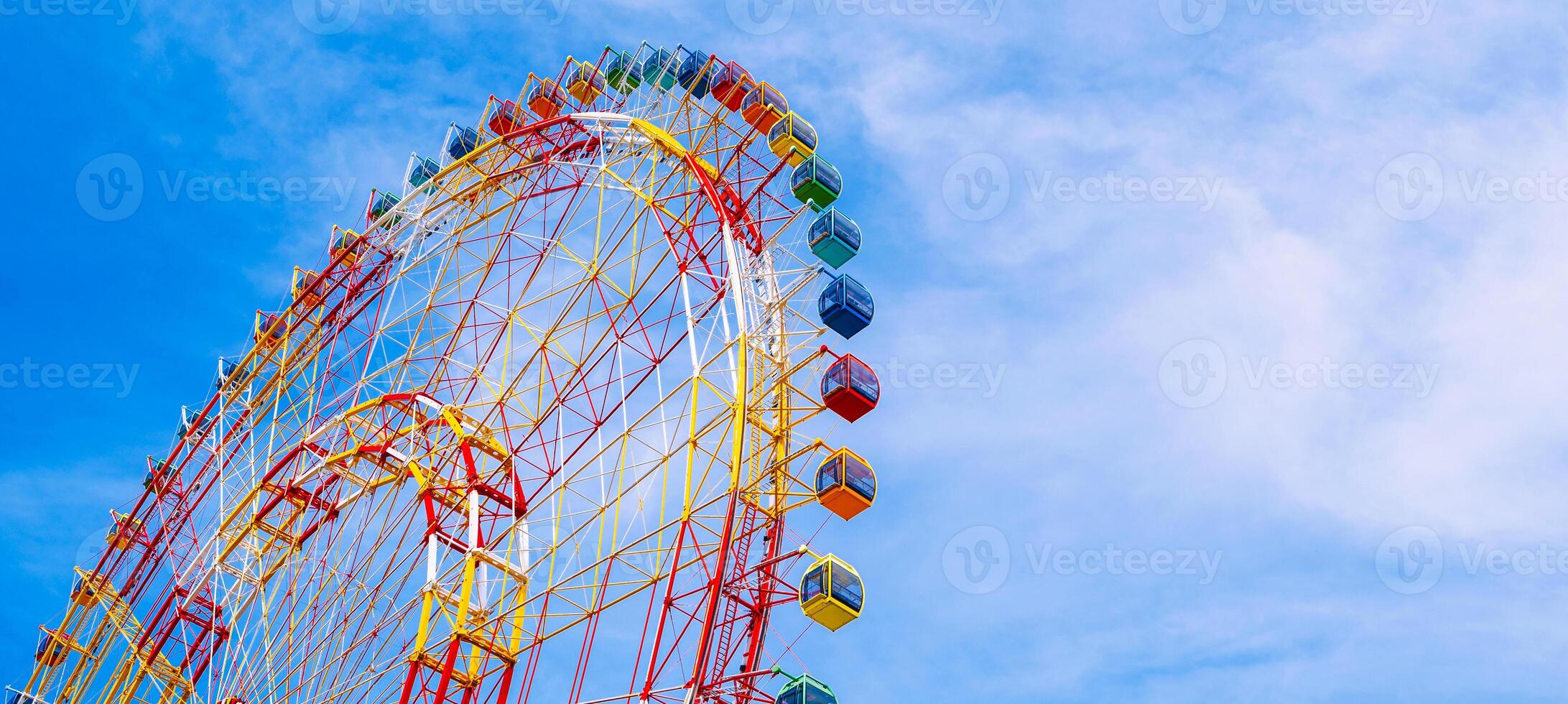 The majestic Ferris wheel stands against the clear blue sky. Panoramic view. photo