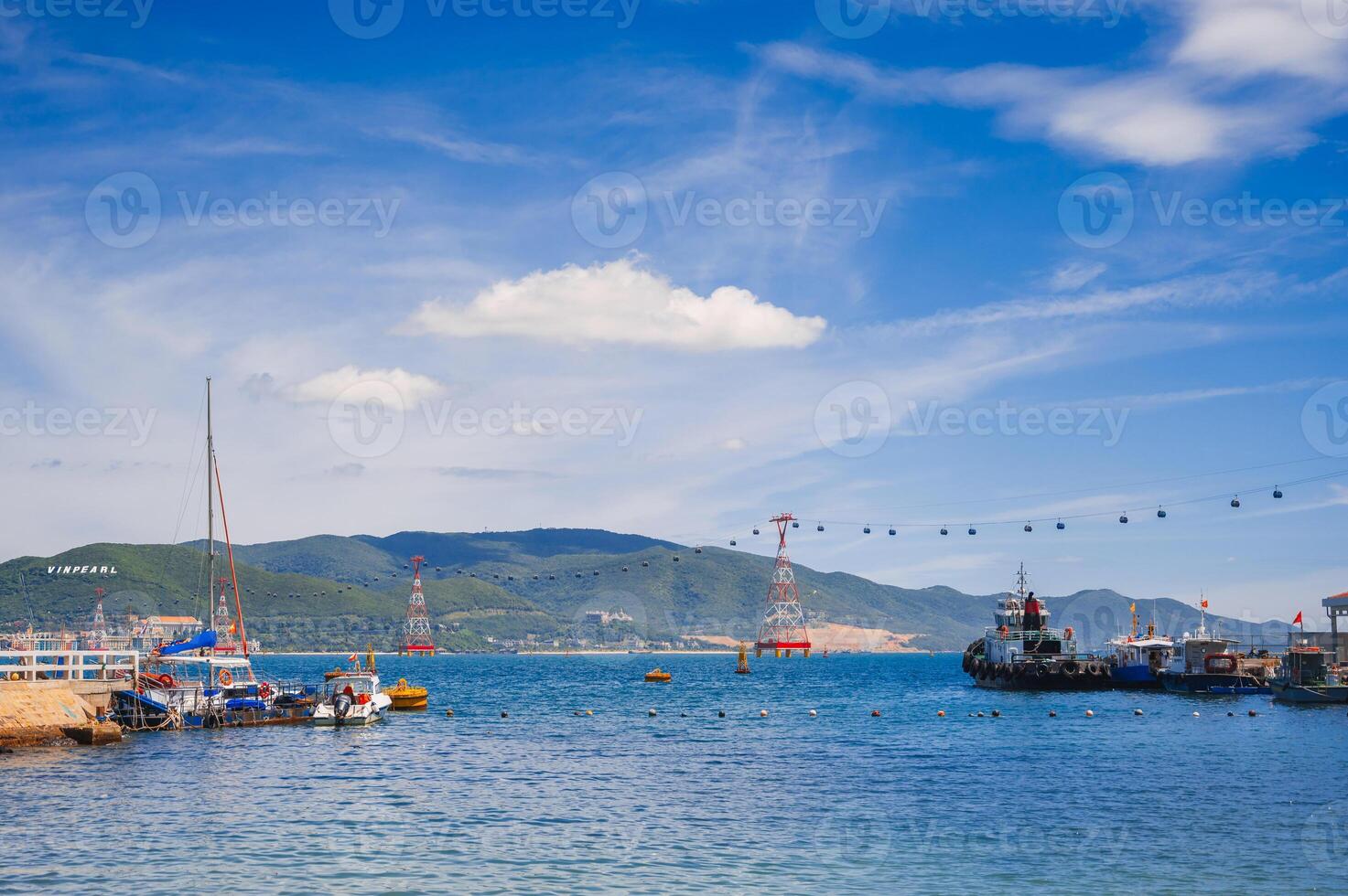A landscape with Vietnamese boats in the sea and a view of the island of Vinperl. photo