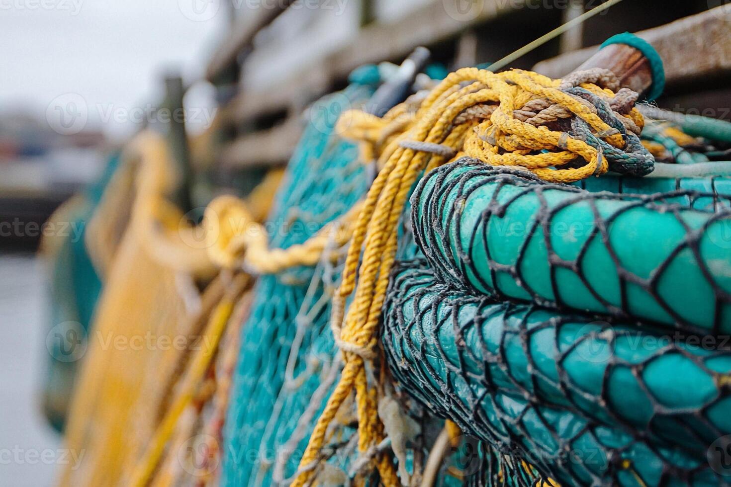 Fishing nets hanging at a dock in a coastal town during overcast weather photo
