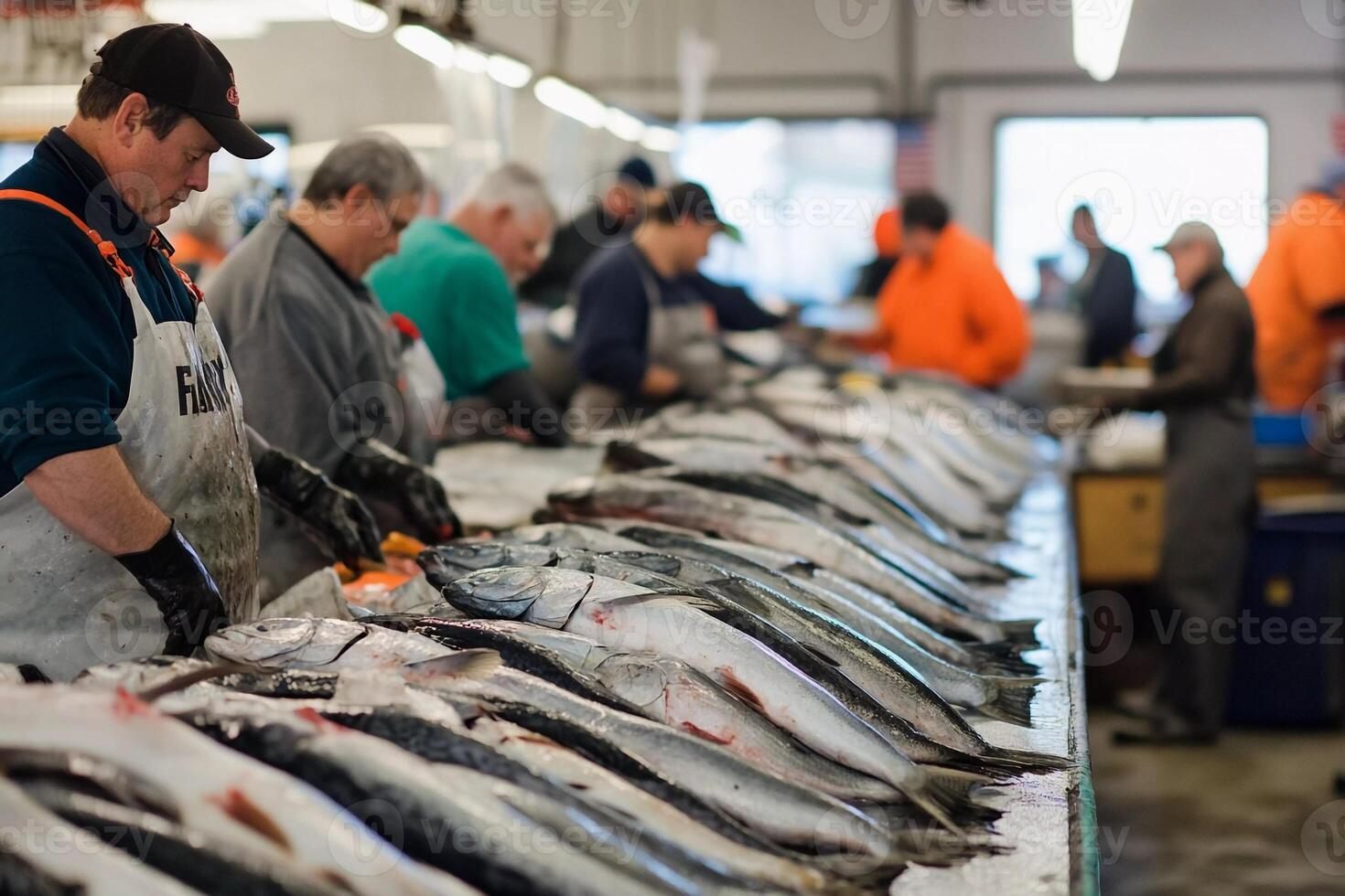 People are standing around a table with fish on it photo
