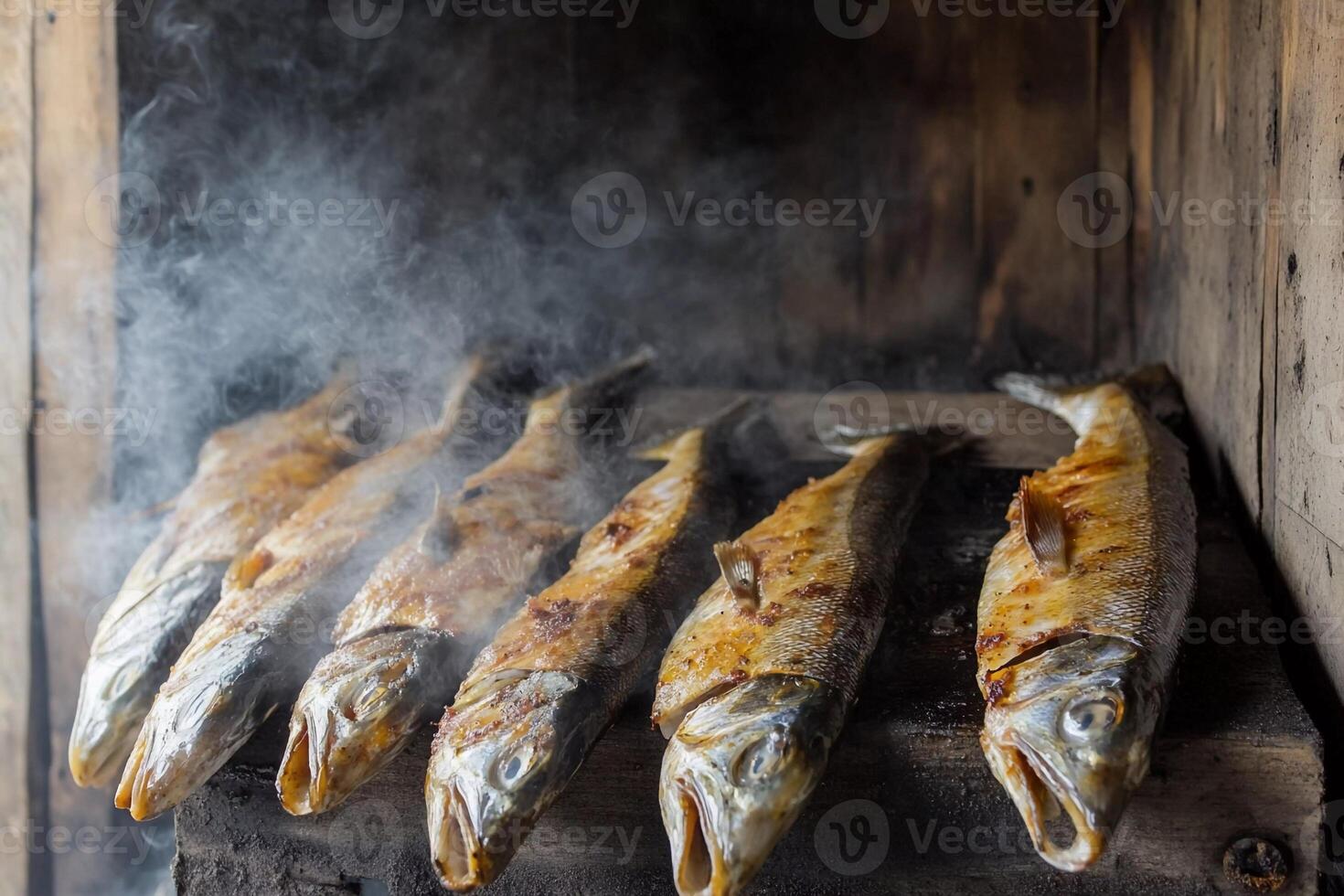 Freshly smoked fish drying in a traditional smoking chamber in a rustic setting photo