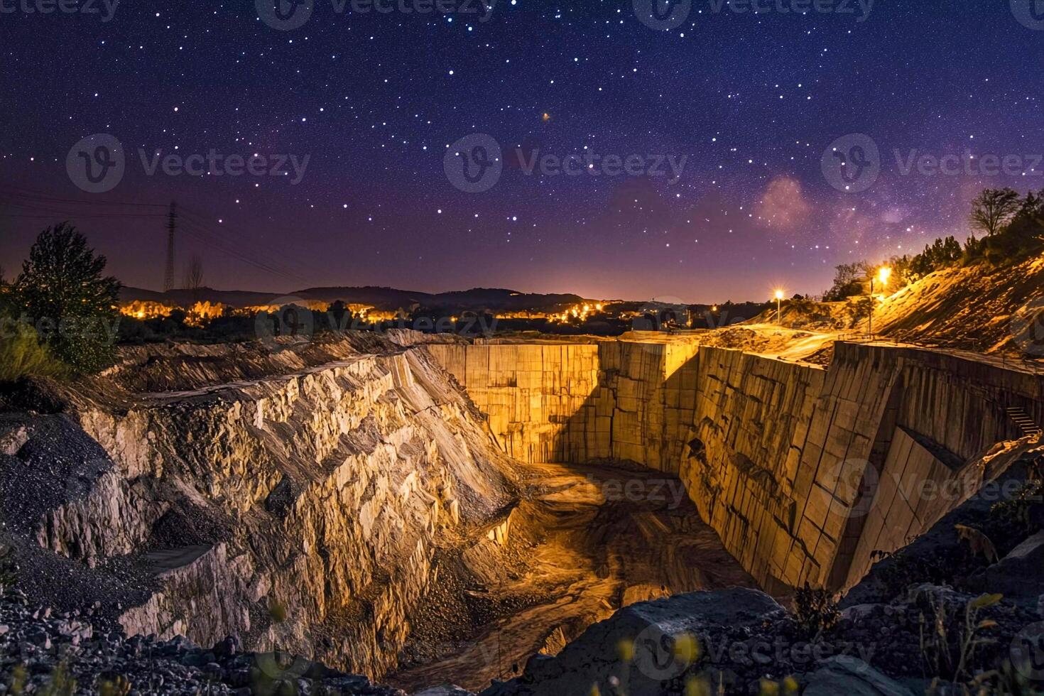 The night sky over a quarry with a large pit photo