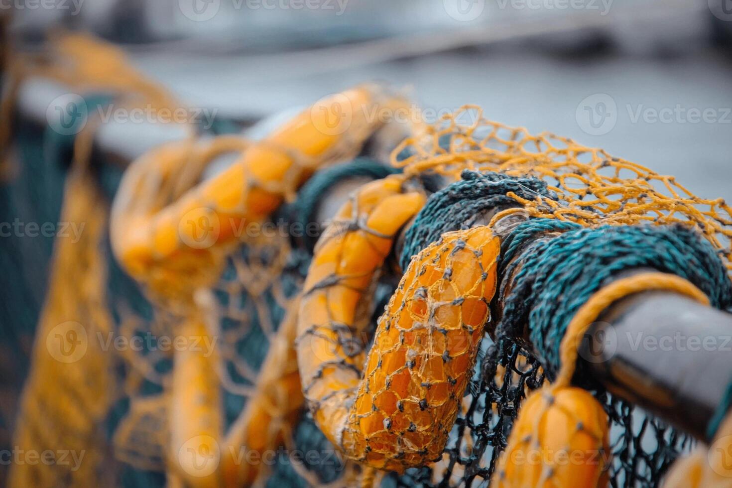 Fishing nets hung out to dry on a boat dock near the coast in the early morning light photo